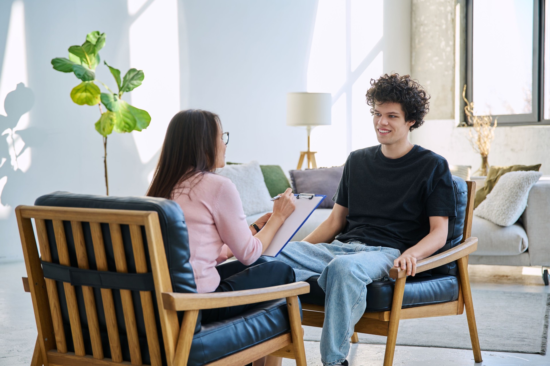 Young man in mental therapy session in office of social psychologist,counselor
